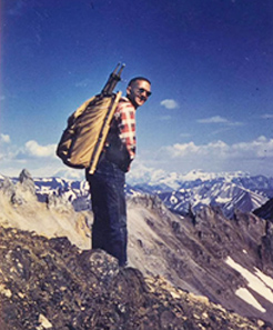 photo of Jim Edwards with backpack high up in the remote mountains