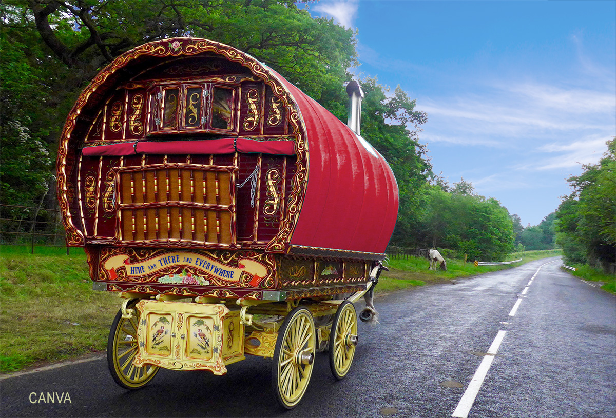 Photo of colorful Gypsy wagon with sign on the back that reads "Here and there and everywhere"